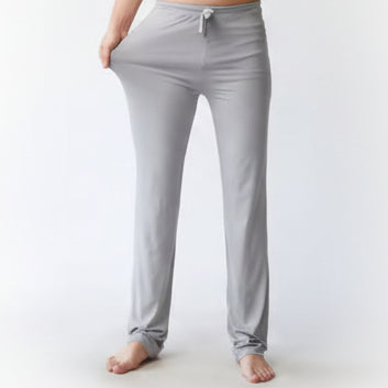Gray lounge pants worn by a person on a white background