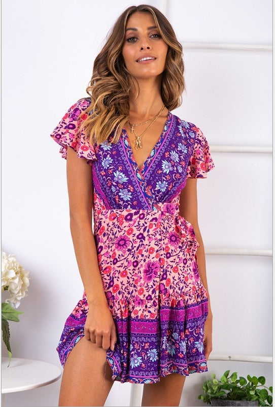 Woman wearing a colorful floral dress with a white background