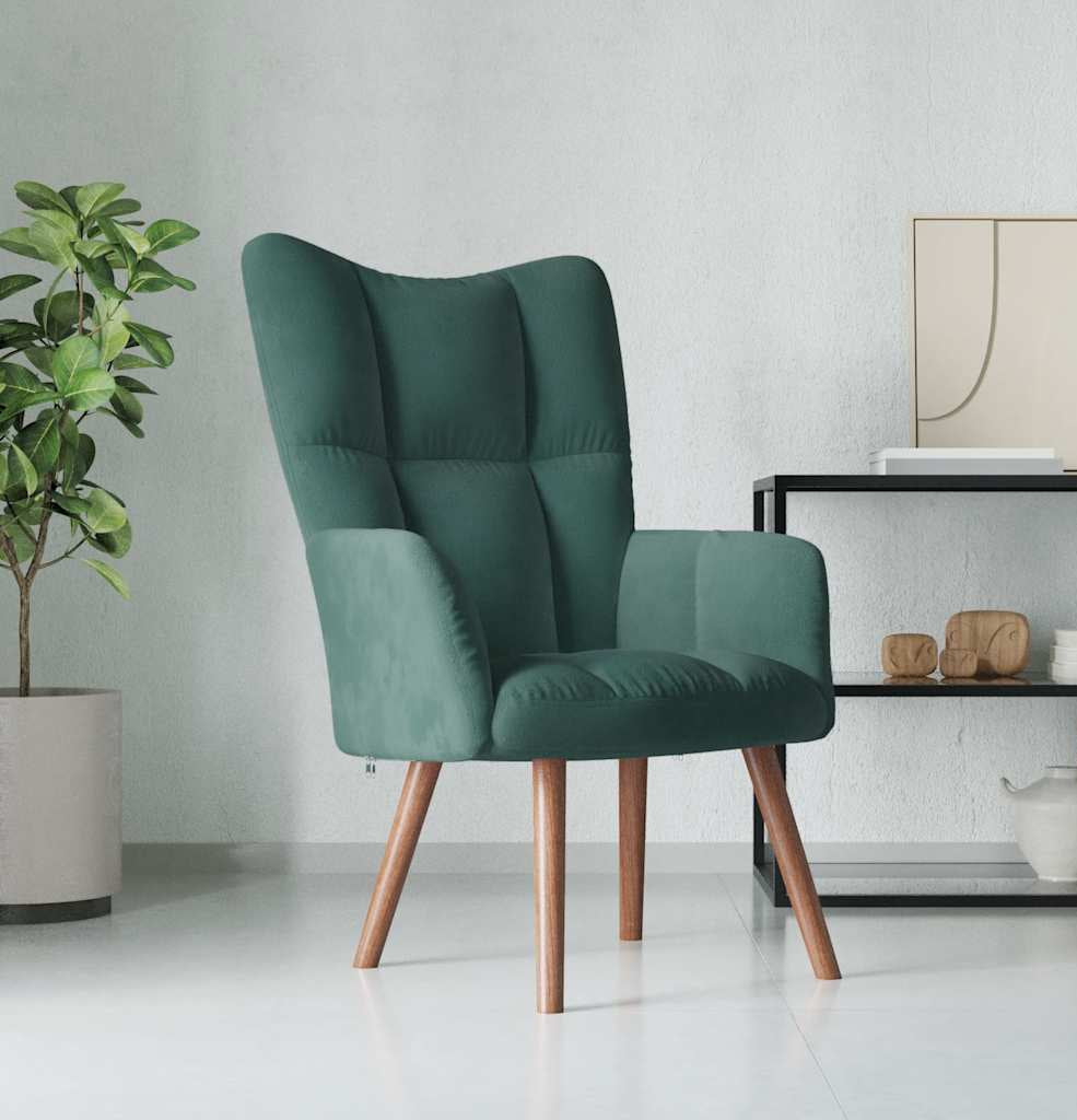Green armchair in a modern living room setting with a plant and decorative items.