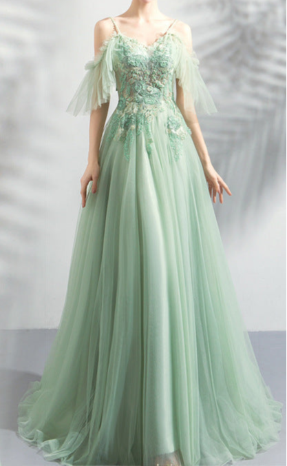 Two views of a woman wearing a light green evening gown with floral lace details on a white background.