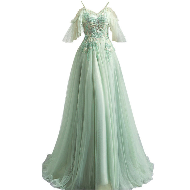 Mint green evening gown with lace detailing on a white background