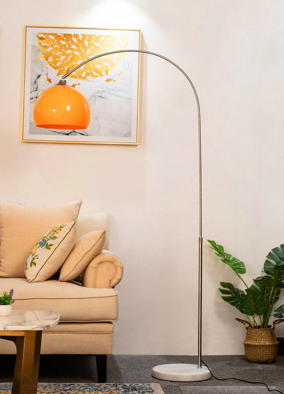 Living room with a floor lamp, sofa, and plant