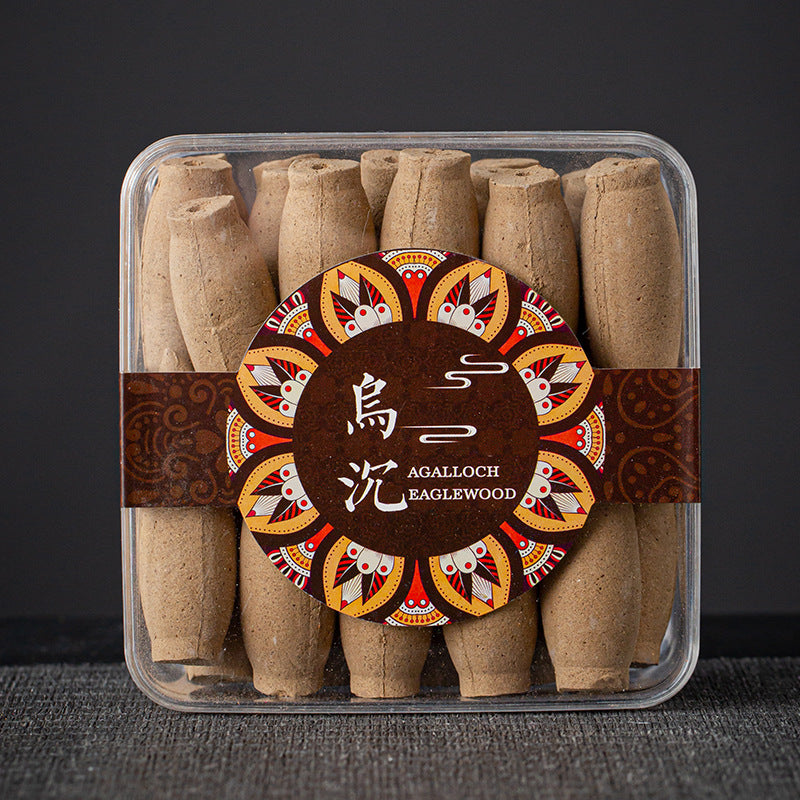 Packaged Agalloch Eaglewood cones with decorative label on a dark background