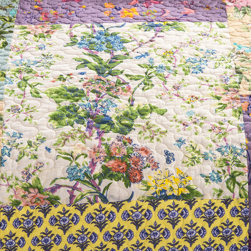 Floral quilt with a colorful pattern on a white background