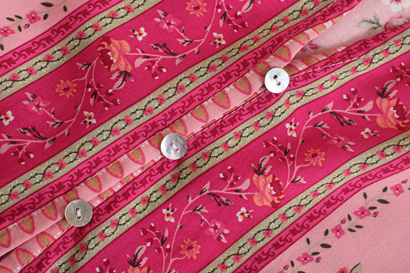Close-up of pink fabric with floral patterns and buttons