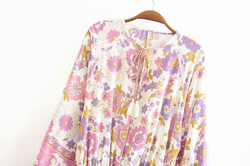 Floral patterned garment on a hanger against a white background