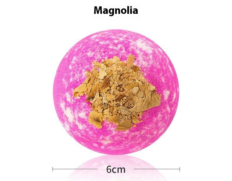 Pink bath bomb with gold flakes on a white background, labeled 'Bath Bombs Magnolia'.