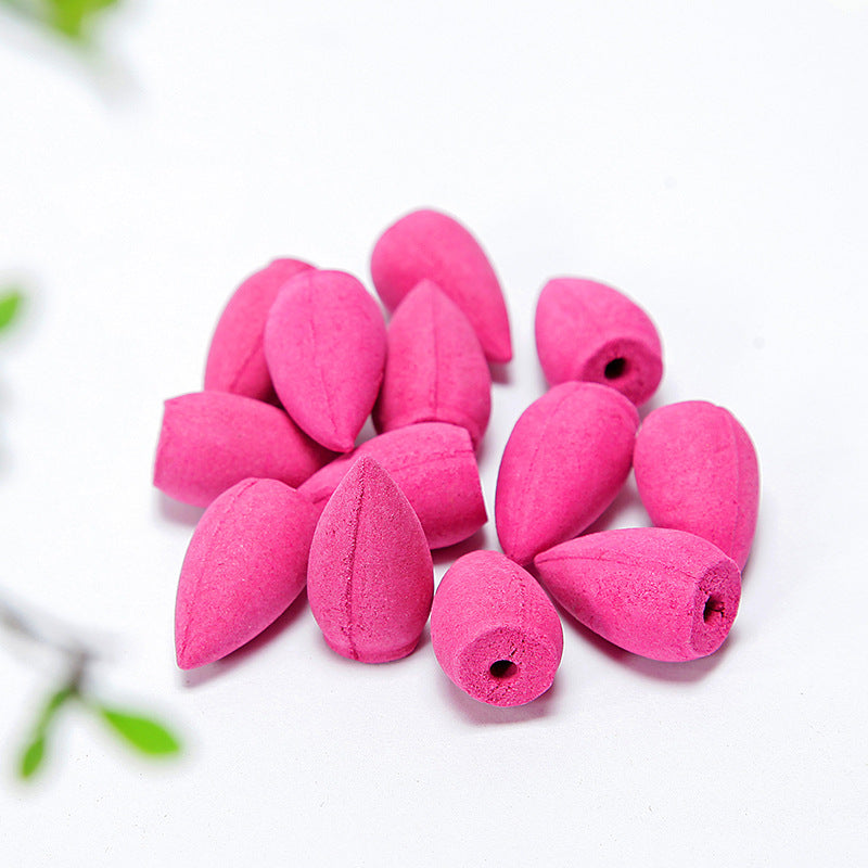 Pink incense cones on a white background