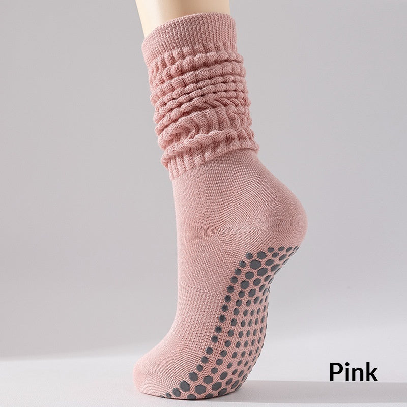 Pink sock with textured top and non-slip bottom on a gray background