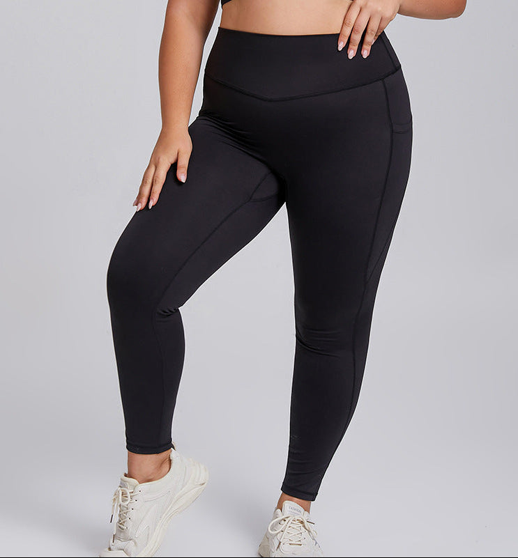 Person wearing black leggings on a light gray background