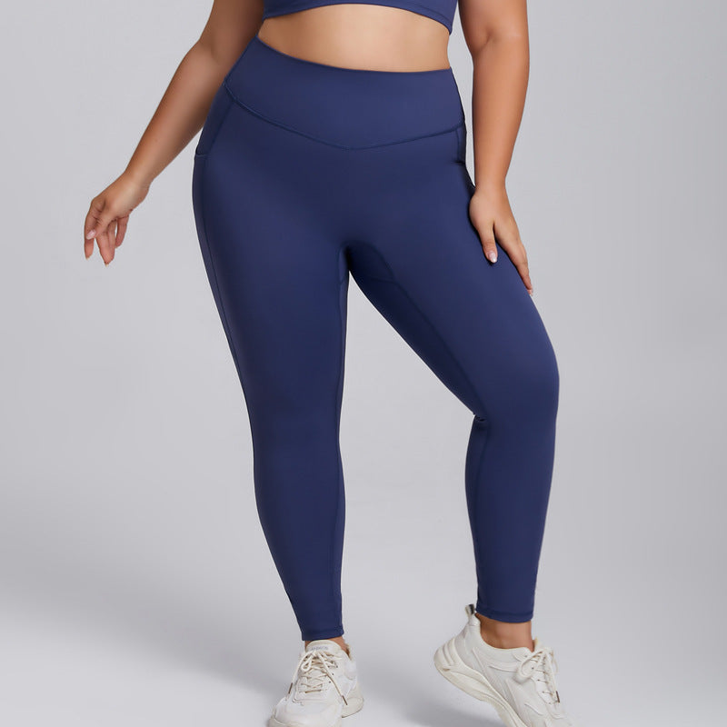 Person wearing navy blue leggings on a light gray background