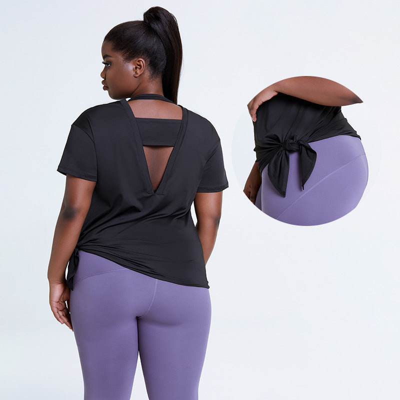 Woman wearing a black open-back top and purple leggings with an inset showing a close-up of the top.