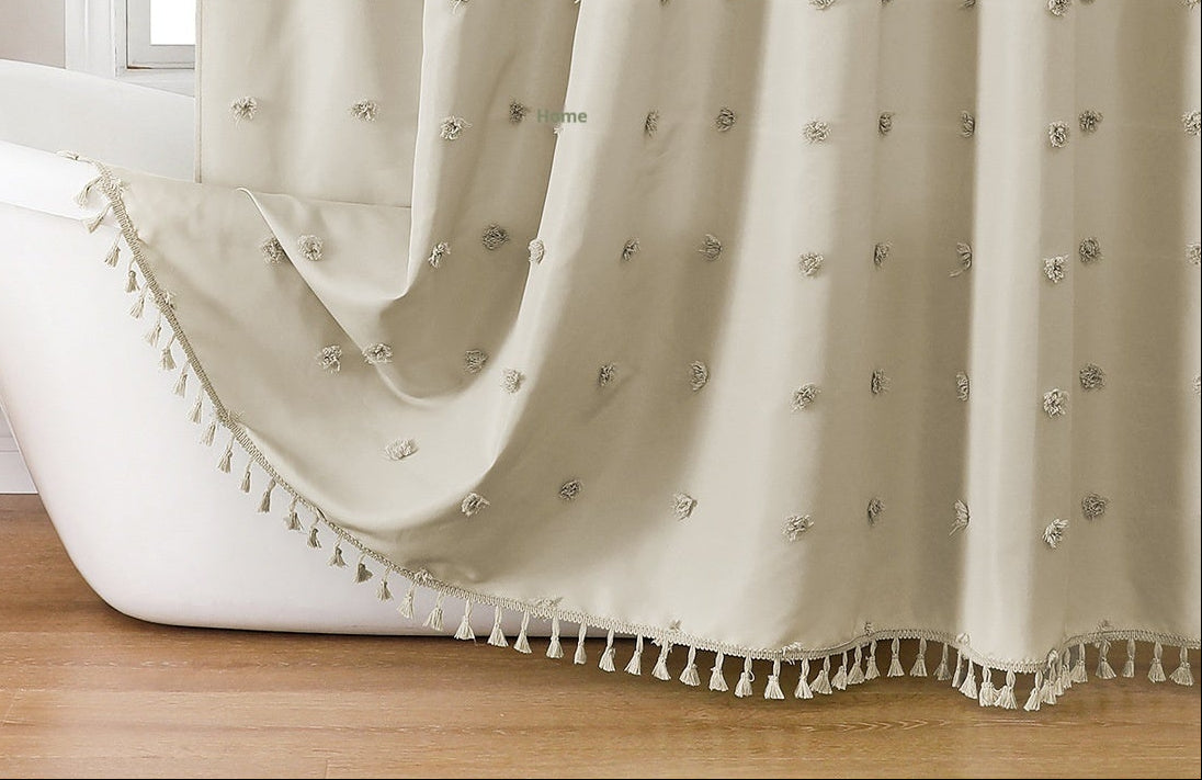Bathroom with a bathtub and decorative curtain featuring tassels.