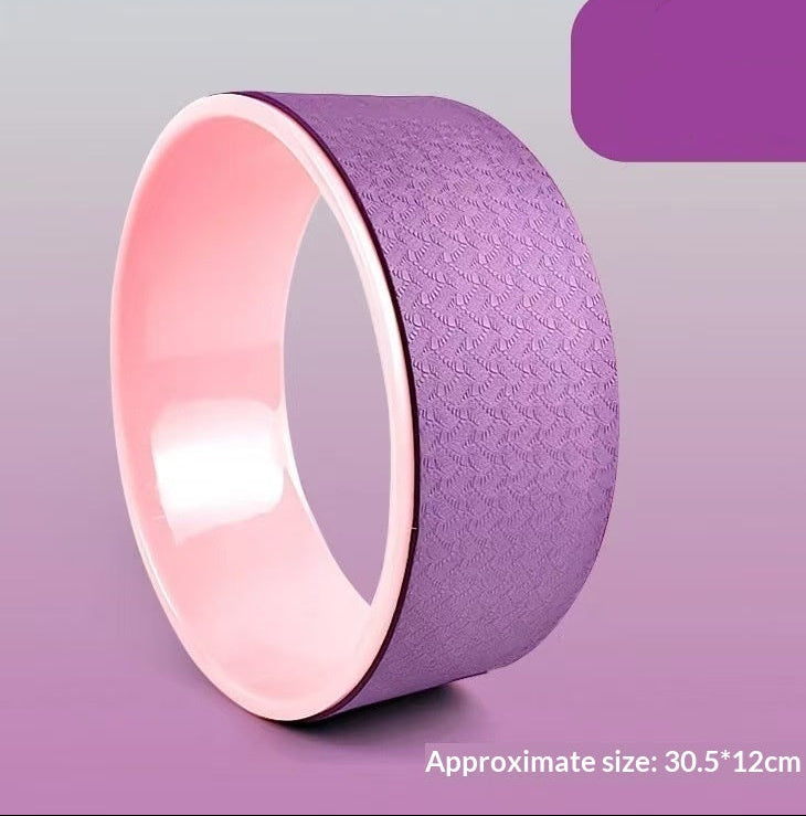 Purple and pink yoga wheel with size and difficulty level text on a purple background