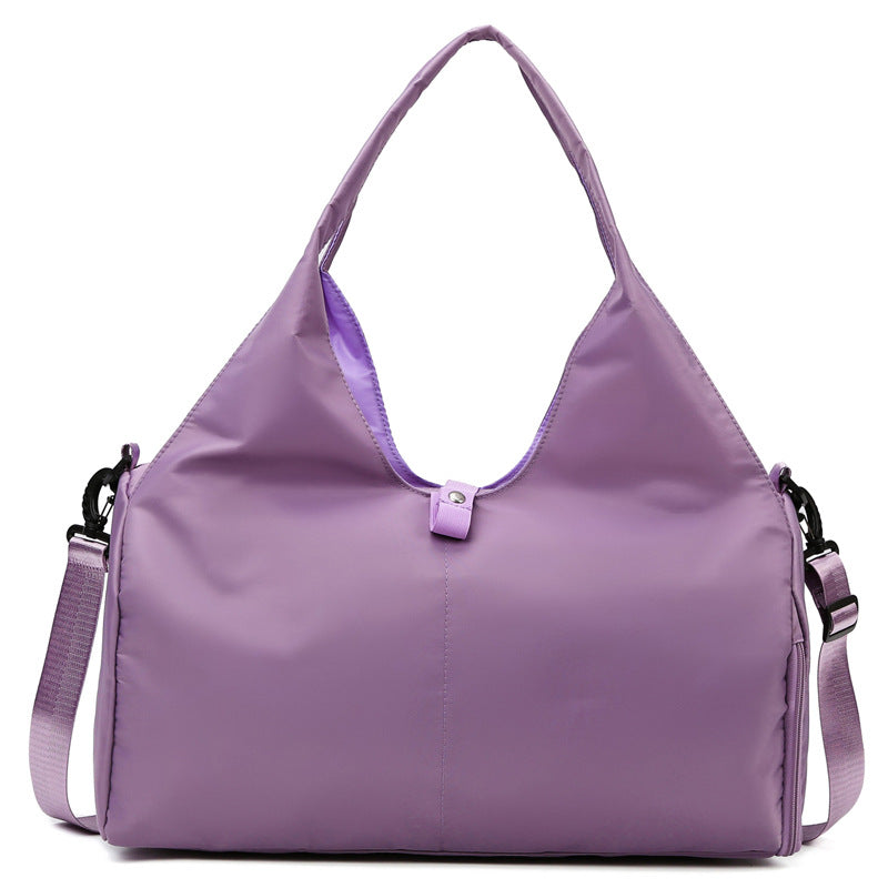 Purple handbag with a shoulder strap on a white background
