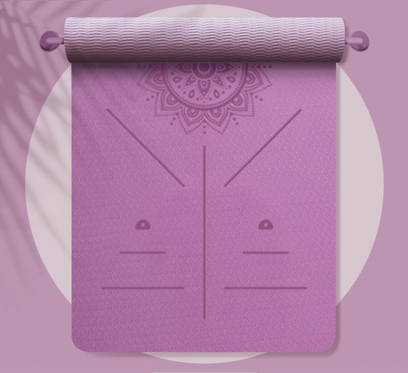 Purple yoga mat with a mandala design on a matching purple background