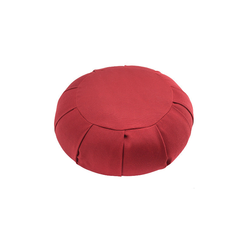 Red meditation cushion on a white background
