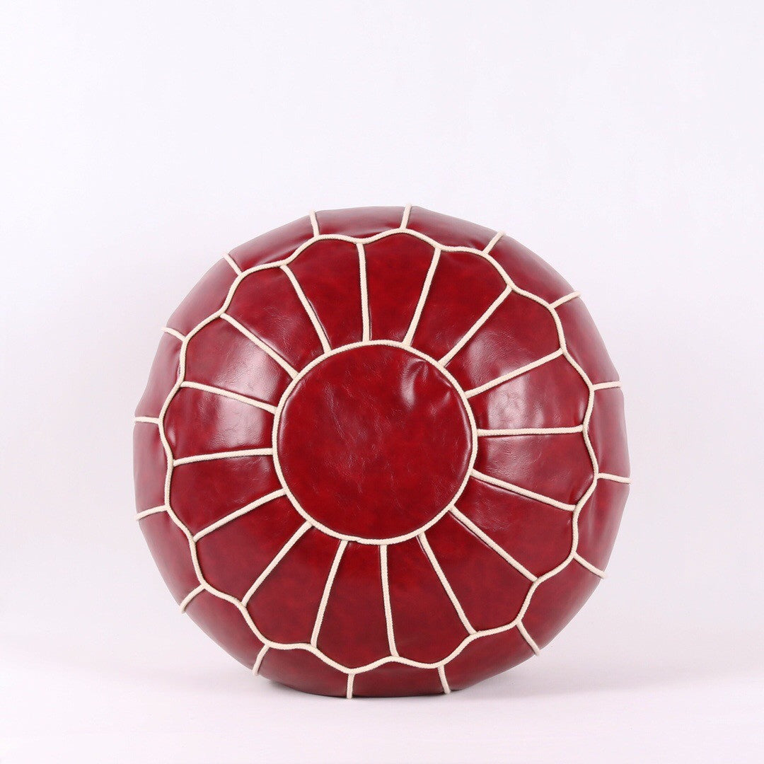 Red leather ottoman with a geometric pattern on a white background