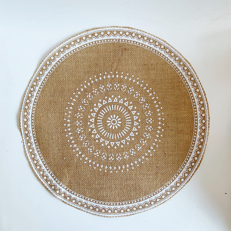 Round woven mat with a geometric pattern on a white background
