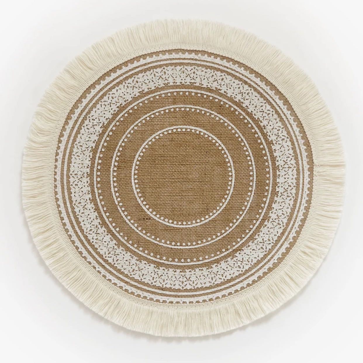 Round woven placemat with concentric circle pattern and tassels on a white background