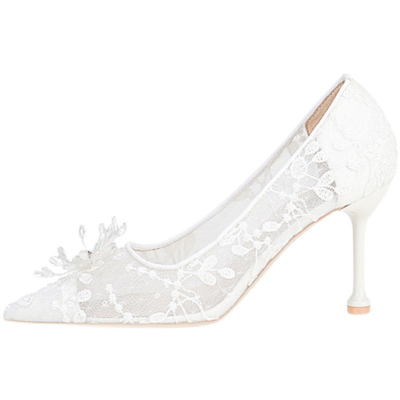 White lace high-heeled shoes on a white background