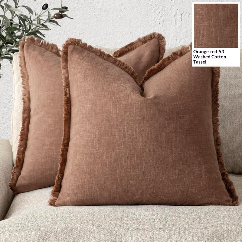 Brown textured pillows with frayed edges on a beige sofa, featuring a color swatch labeled 'Orange-red-53 Washed Cotton Tassel'.