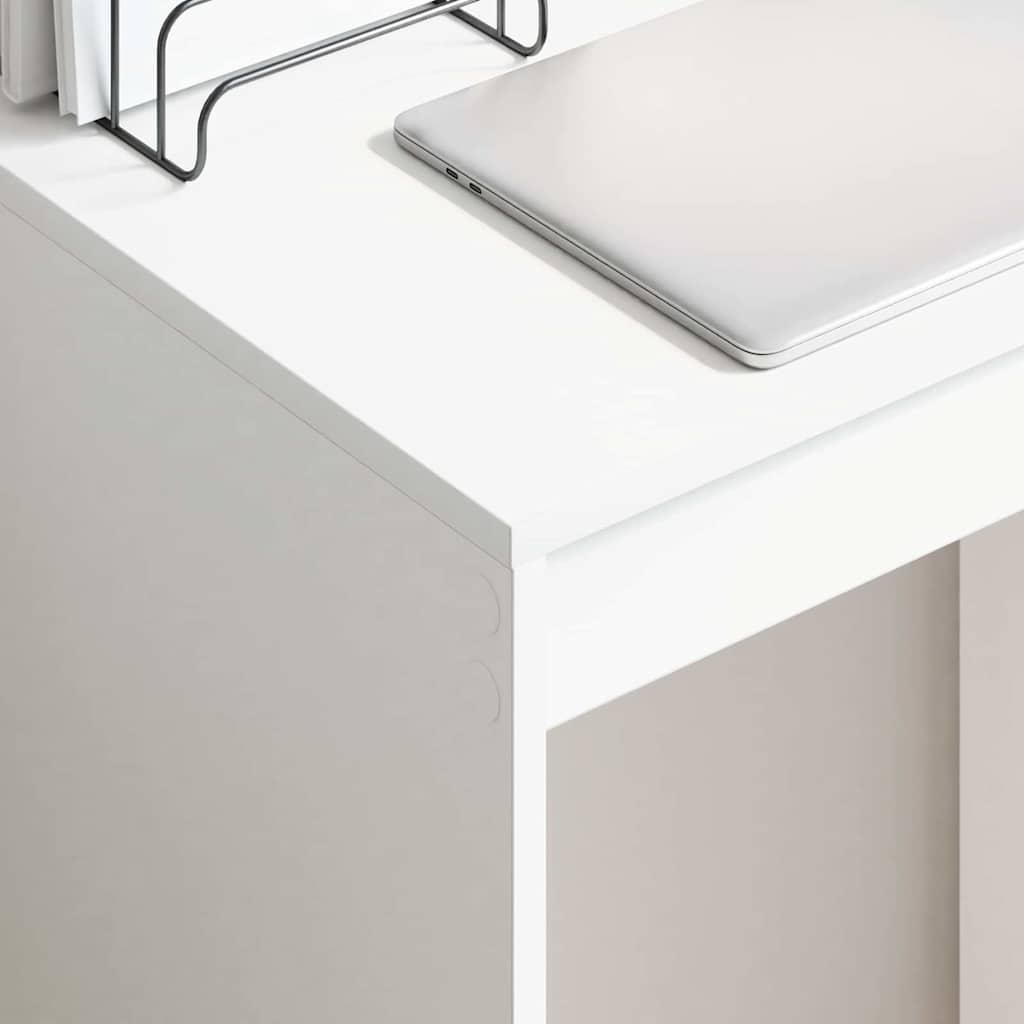 White desk with a laptop on a white surface