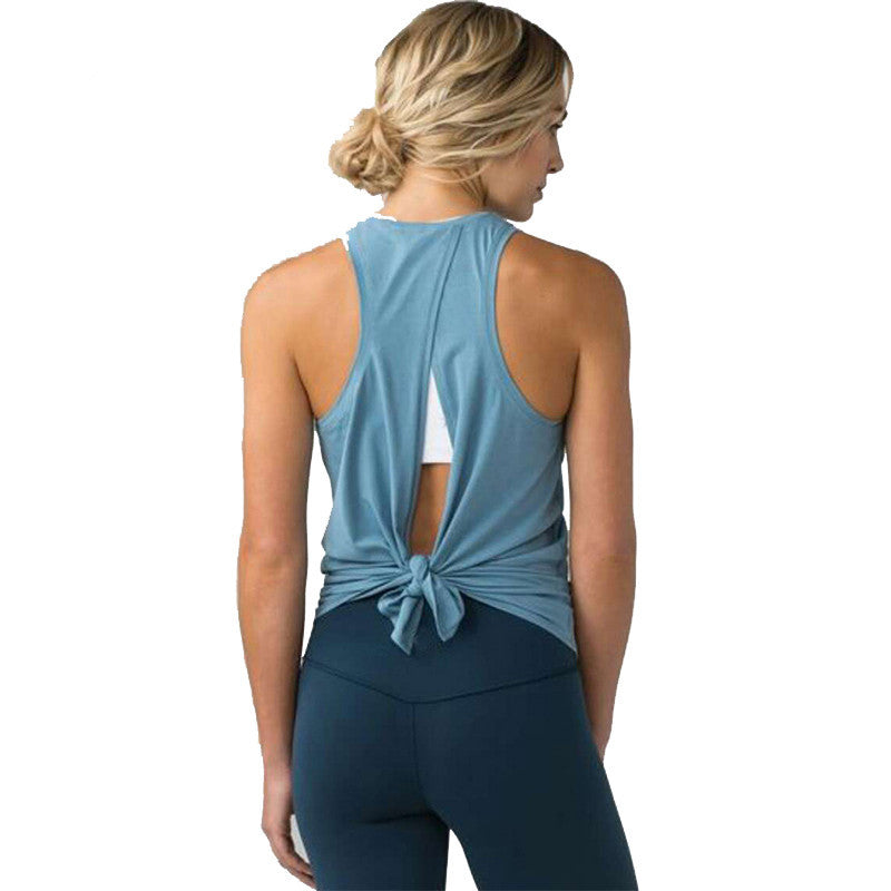 Woman wearing a blue tank top with a knot detail on a white background