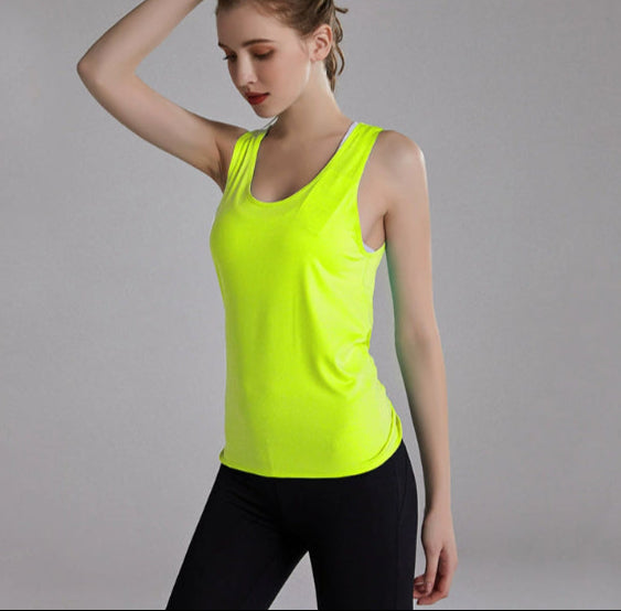 Woman wearing a bright green tank top against a gray background
