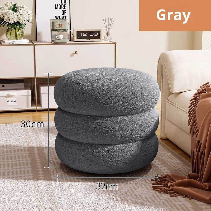 Gray pouf with dimensions in a living room setting