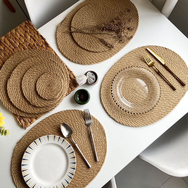 Woven placemats with cutlery on a white table