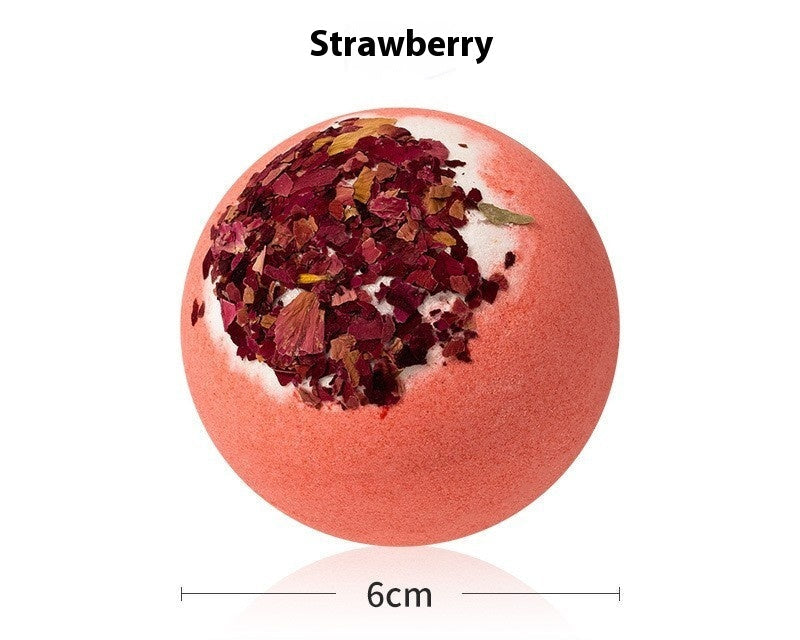 Strawberry bath bomb with visible ingredients on a white background