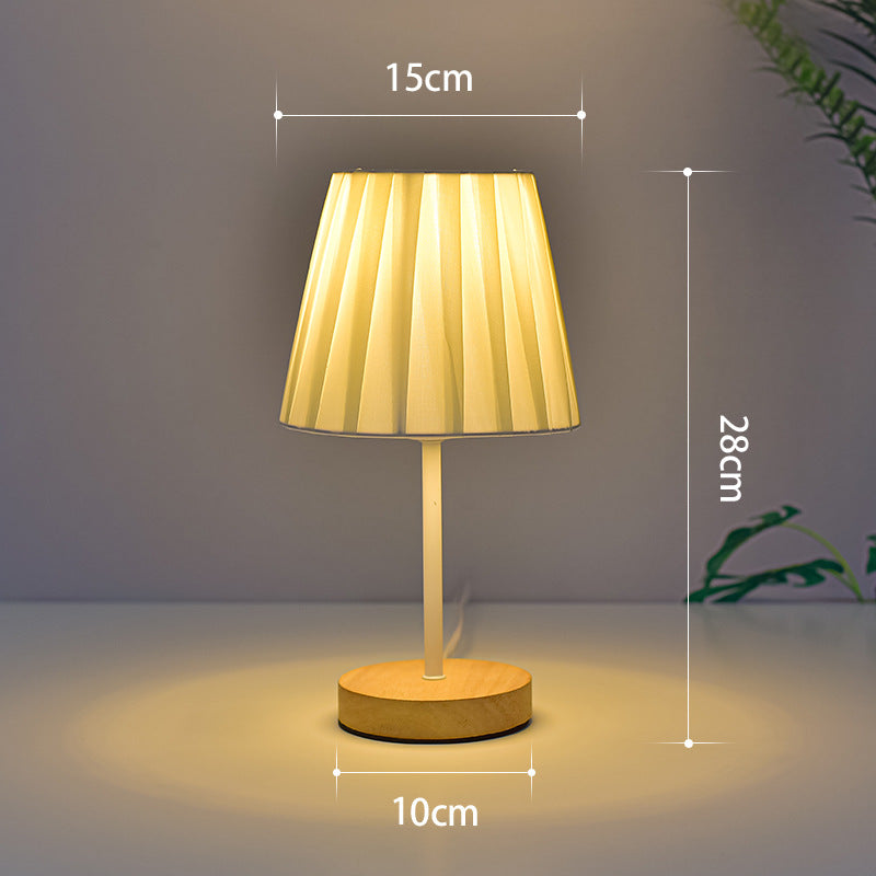 Table lamp with dimensions indicated on a neutral background