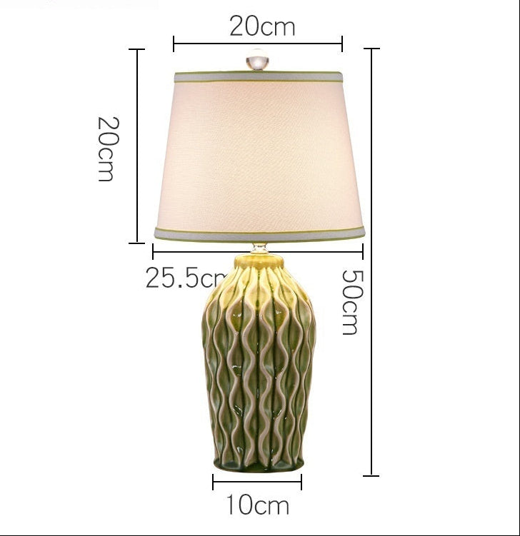 Table lamp with green textured base and beige shade, dimensions displayed.