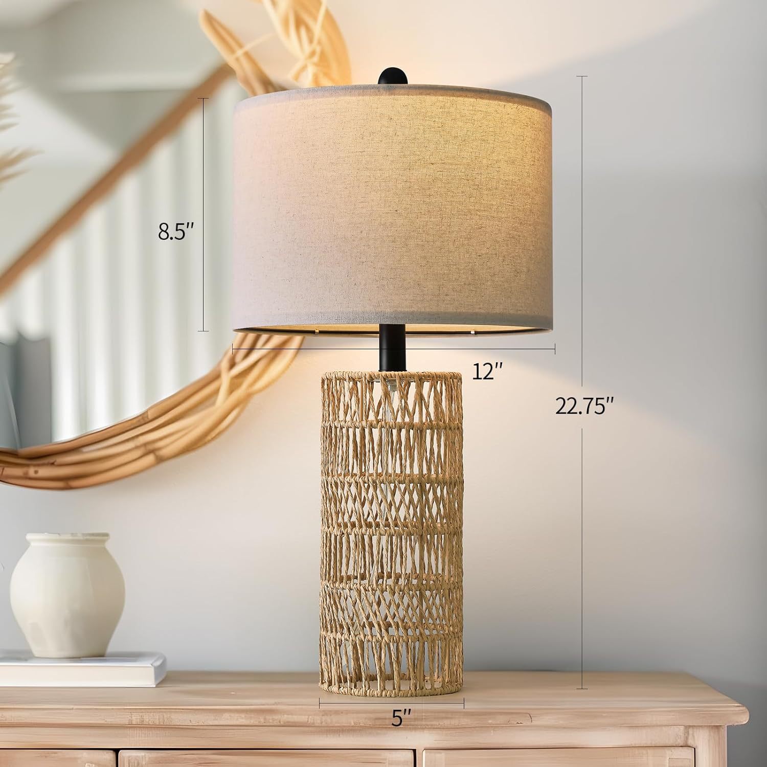 Table lamp with wicker base and beige shade on a wooden surface, with measurements indicated.