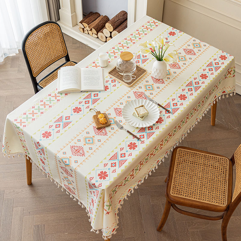 Tablecloth with geometric pattern on a dining table with chairs.