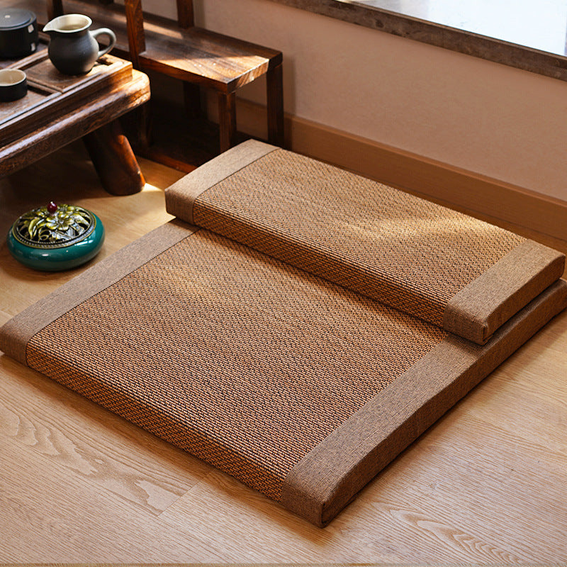 Two tatami mats on a wooden floor with a small table and decorative items in the background.