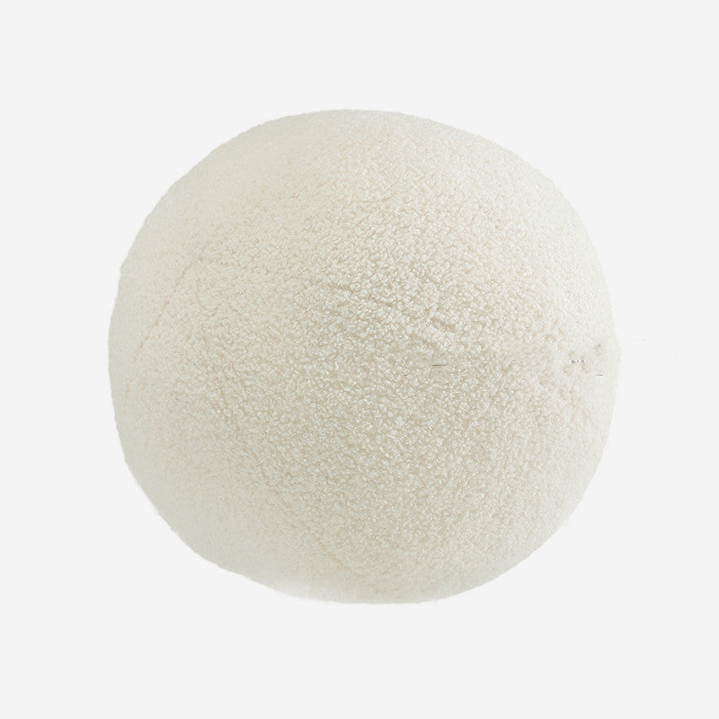 Round, textured white object on a light beige background