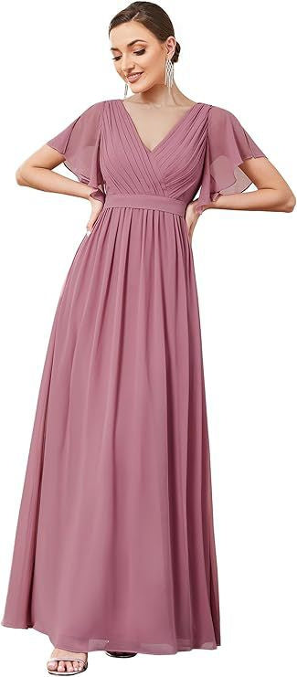 Woman wearing a long mauve dress with short sleeves.