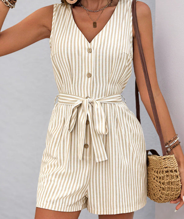 Woman wearing a striped romper with a plain background