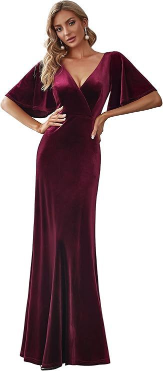 Burgundy velvet evening gown with cape sleeves worn by a model on a white background