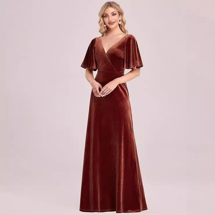 Brown velvet evening gown on a model against a light pink background