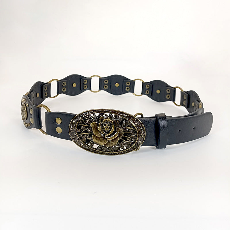 Black belt with a decorative gold buckle on a white background