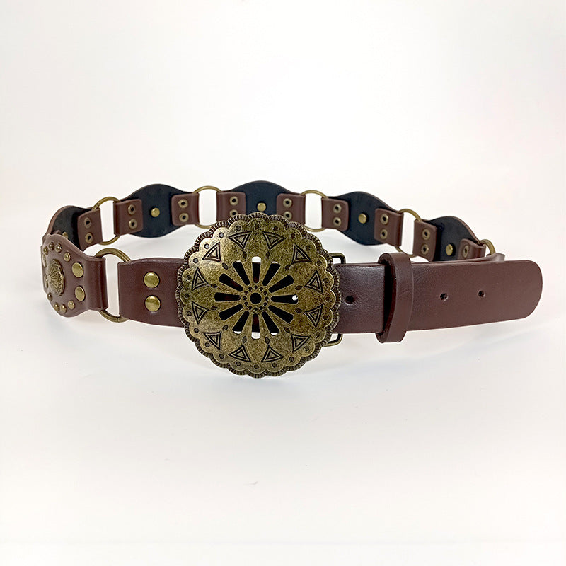 Brown leather belt with decorative brass buckle on a white background