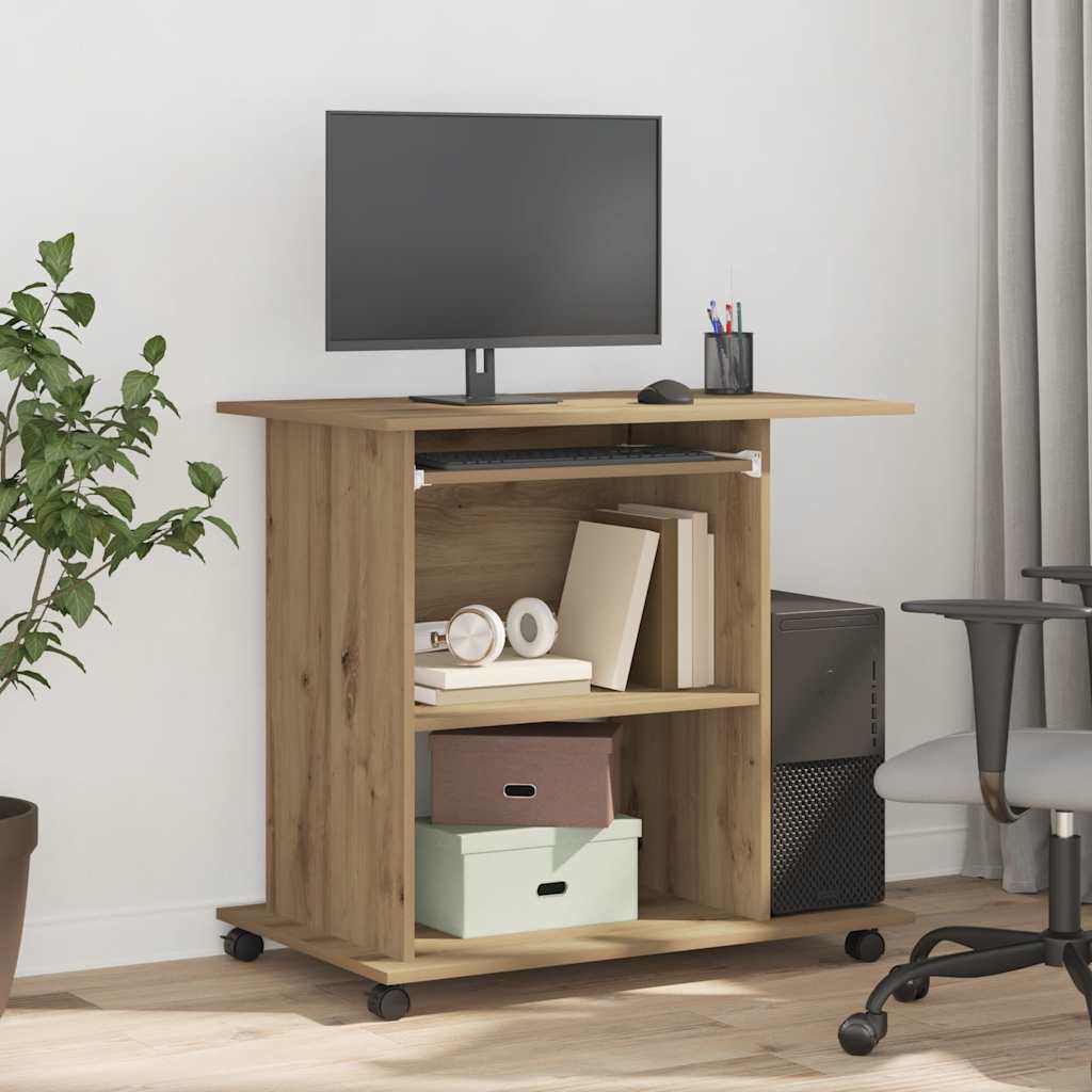 Wooden desk with a computer monitor, books, and office supplies in a room with a plant and chair.