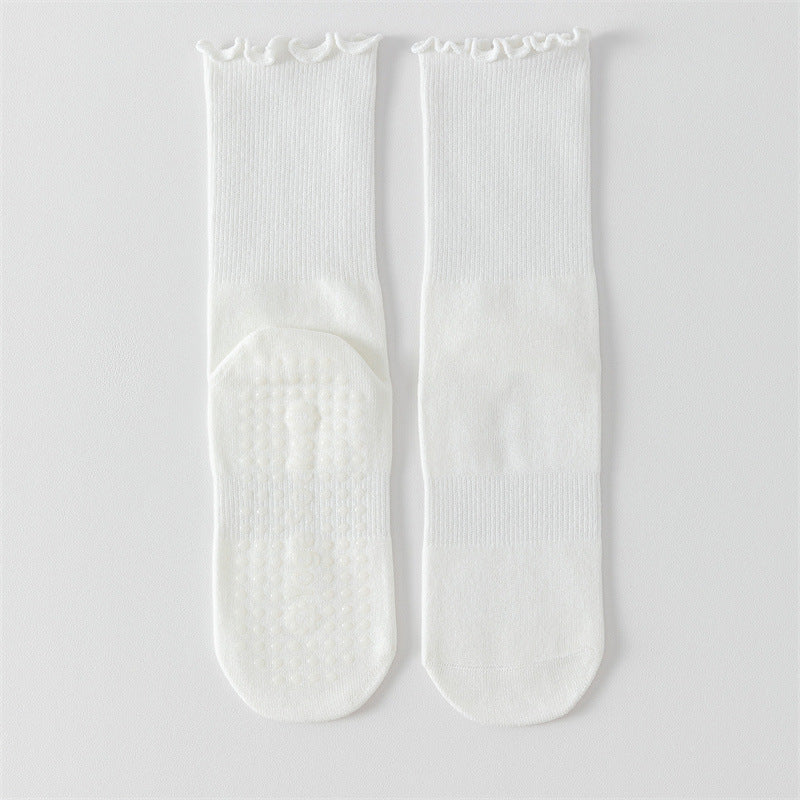 White socks with textured sole on a light gray background