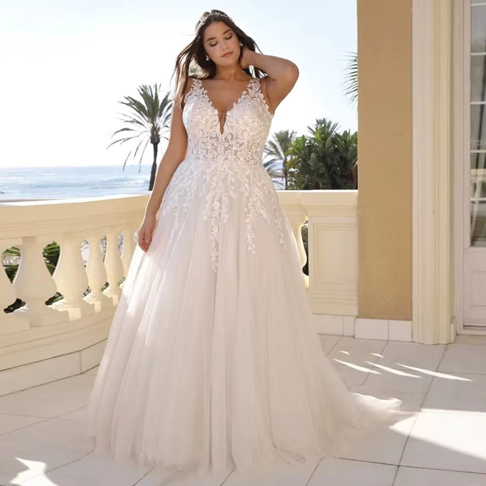 Woman in a white wedding dress on a balcony with ocean view