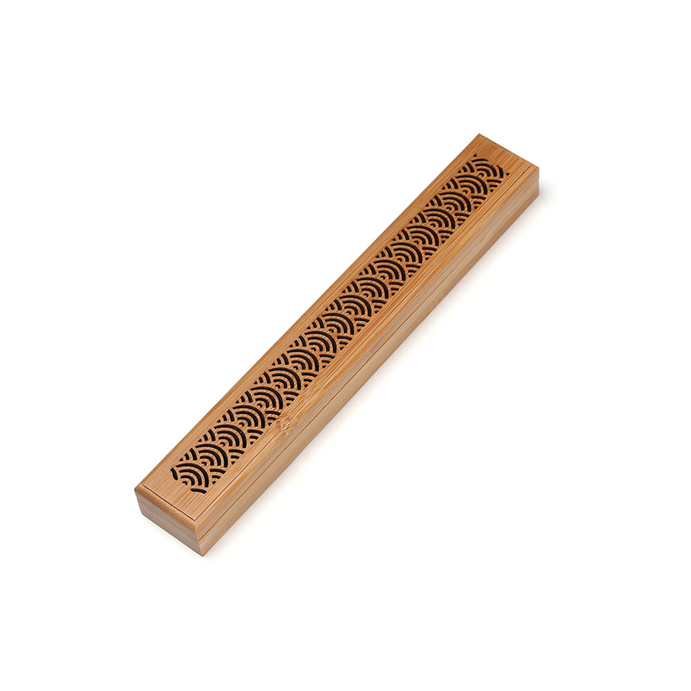 Wooden incense stick holder with decorative patterns on a white background