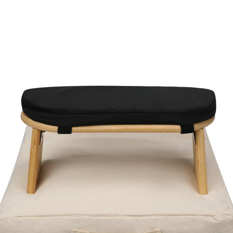 Wooden stool with a black cushion on a white background