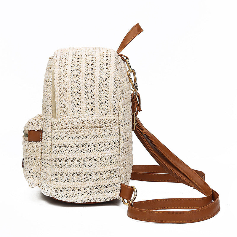 Crocheted backpack with brown straps on a white background